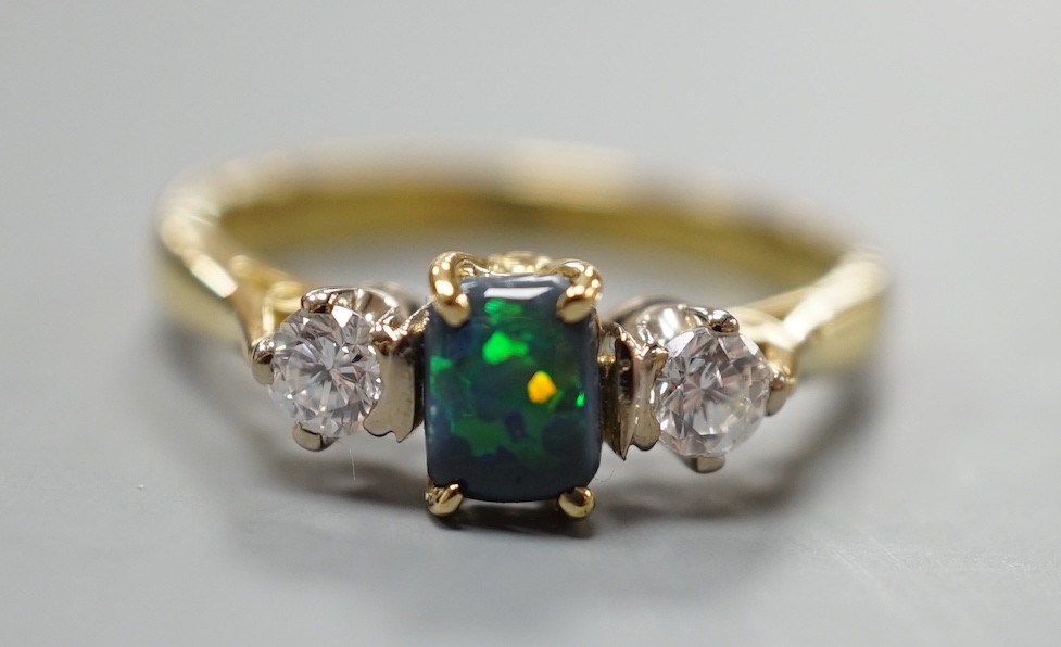 A modern 18ct gold, black opal and diamond set three stone ring, size Q, gross weight 4.6 grams